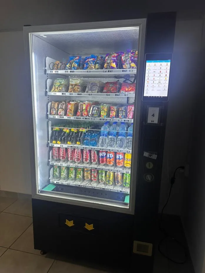 A VM Services vending machine in the common area of PH Amitié, stocked with snacks and drinks